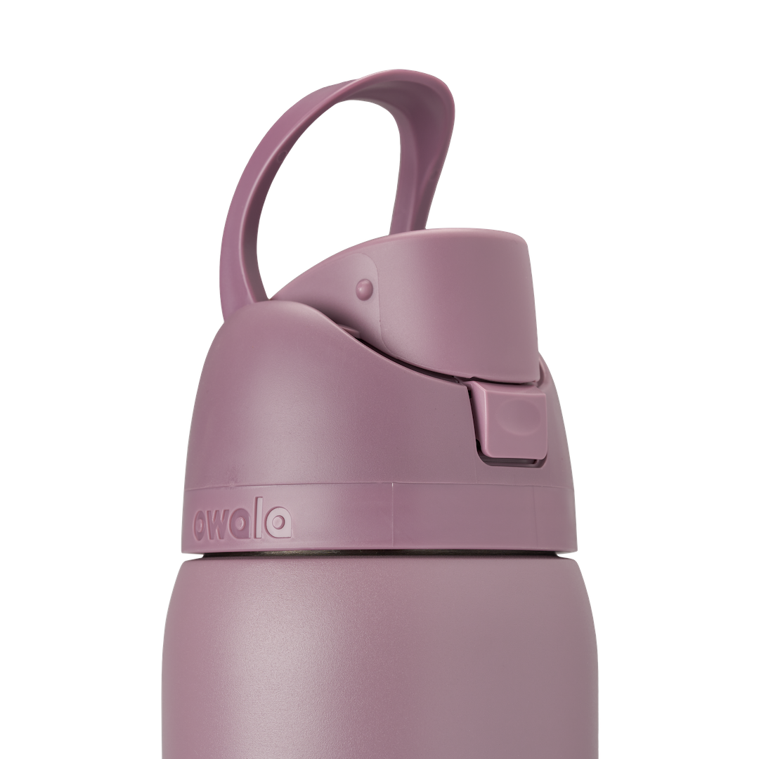 Owala FreeSip 32oz Spring Revival, lid detail showing dusty mauve flip cap with carry loop folded flat, accent band and Owala logo visible
